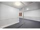 Spacious basement features carpeting, half-wall trim, support beam, and recessed ceiling lighting at 1924 Strebor St, Durham, NC 27705