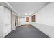 Large basement with gray carpeting, half-wall trim, door, and bi-fold closet doors at 1924 Strebor St, Durham, NC 27705