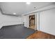 Basement with carpet, bi-fold door, and potential for storage space and customization at 1924 Strebor St, Durham, NC 27705