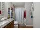 Bathroom featuring a shower with patterned curtain and vanity with granite countertop at 1924 Strebor St, Durham, NC 27705