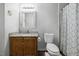 Bathroom featuring a shower with patterned curtain and vanity with granite countertop at 1924 Strebor St, Durham, NC 27705