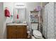 Bathroom featuring a shower with patterned curtain and vanity with granite countertop at 1924 Strebor St, Durham, NC 27705