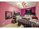 Vibrant pink bedroom with bed and television at 1924 Strebor St, Durham, NC 27705