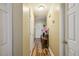 Hallway with wood floors, white doors, and a console table with decor at 1924 Strebor St, Durham, NC 27705
