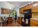 Charming kitchen featuring wooden cabinets, granite countertops, and a cozy breakfast nook surrounded by plants at 1924 Strebor St, Durham, NC 27705