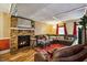 Relaxing living room with a brick fireplace, plush sectional sofa, and large windows providing ample light at 1924 Strebor St, Durham, NC 27705