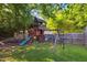 Backyard featuring a wooden playground set with slide and swings, perfect for Gathering fun at 1924 Strebor St, Durham, NC 27705