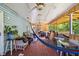 Covered porch with ceiling fans, wood flooring, a colorful hammock and seating area at 1924 Strebor St, Durham, NC 27705