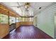 Spacious covered porch with ceiling fans, wood flooring, and views of the surrounding greenery at 1924 Strebor St, Durham, NC 27705