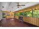Covered porch with wood flooring, ceiling fans, wood paneling, and gated entryway at 1924 Strebor St, Durham, NC 27705