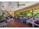 Covered porch with ceiling fans, wood flooring, a colorful hammock and seating area at 1924 Strebor St, Durham, NC 27705