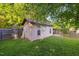 Backyard featuring a shed with windows and ample storage space, perfect for storing gardening equipment at 1924 Strebor St, Durham, NC 27705