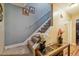 Well-maintained staircase with carpeted steps, decorative wall art, and a stylish side table with floral decor at 1924 Strebor St, Durham, NC 27705