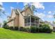 Well-maintained backyard with a screened porch, lush lawn, and professionally landscaped garden at 200 Heather Brook Cir, Spring Lake, NC 28390