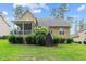 Inviting backyard featuring a screened porch and a well-maintained lawn with beautiful landscaping at 200 Heather Brook Cir, Spring Lake, NC 28390