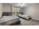 Comfortable bedroom featuring two beds, soft lighting, and neutral decor at 200 Heather Brook Cir, Spring Lake, NC 28390