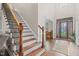 Inviting foyer featuring hardwood floors, a staircase, and a stained-glass front door, creating a grand entrance at 200 Heather Brook Cir, Spring Lake, NC 28390