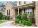 Charming home featuring a brick facade, black shutters, and meticulously maintained landscaping at 200 Heather Brook Cir, Spring Lake, NC 28390