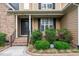 Inviting front entrance with elegant columns, manicured shrubs, and brick accents at 200 Heather Brook Cir, Spring Lake, NC 28390