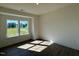 Sunlit bedroom with hardwood floors and a large window overlooking the green backyard at 214 Alden Way, Angier, NC 27501