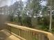Deck view of backyard featuring a wooded area and lawn at 2207 Lambert Rd # 69, Cary, NC 27519