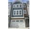 Charming exterior showcasing a two-story home with a white garage door and stone and blue facade at 2207 Lambert Rd # 69, Cary, NC 27519
