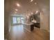 Open concept kitchen with grey cabinetry, a central island, and stainless steel appliances is connected to the living area at 2207 Lambert Rd # 69, Cary, NC 27519