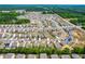Extensive aerial view of a neighborhood featuring numerous houses and scenic greenery at 224 Brisk Dr, Zebulon, NC 27597