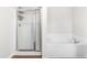Clean and simple bathroom featuring a shower with glass doors and a separate soaking tub at 224 Brisk Dr, Zebulon, NC 27597