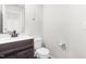 Clean bathroom with a dark wood vanity, white countertop, oval mirror, and modern fixtures at 224 Brisk Dr, Zebulon, NC 27597