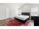 Bright bedroom featuring a vaulted ceiling, natural light, and a modern platform bed with side tables at 224 Brisk Dr, Zebulon, NC 27597
