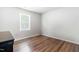 Neutral bedroom with wood floors, a bright window, and side table at 224 Brisk Dr, Zebulon, NC 27597