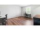 Bright, empty bedroom with hardwood floors and ample natural light from a large window at 224 Brisk Dr, Zebulon, NC 27597