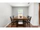 Dining room with modern table set by window, inviting natural light at 224 Brisk Dr, Zebulon, NC 27597