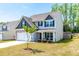 Beautiful two-story home with a well-kept lawn and classic architectural details at 224 Brisk Dr, Zebulon, NC 27597