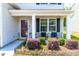Inviting front porch with seating area and well-maintained landscaping at 224 Brisk Dr, Zebulon, NC 27597