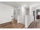 Bright hallway with wood flooring, leading to laundry room and other rooms at 224 Brisk Dr, Zebulon, NC 27597