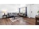 Inviting living room with hardwood floors, neutral walls, large windows, and a comfortable sofa at 224 Brisk Dr, Zebulon, NC 27597