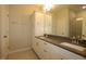 Bathroom featuring double sink vanity, gray countertop, white cabinets and large framed mirror at 2297 Bay Minette Sta # 536, Apex, NC 27502