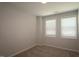 Bedroom with neutral walls, neutral carpet, and two windows at 2297 Bay Minette Sta # 536, Apex, NC 27502
