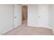 Simple bedroom with carpeted floors, closet, and doorway to hall at 2297 Bay Minette Sta # 536, Apex, NC 27502