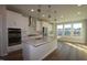 Open-concept kitchen with stainless steel appliances, pendant lighting, an island and views to the living area at 2297 Bay Minette Sta # 536, Apex, NC 27502