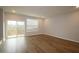 Bright living room with wood floors and sliding glass doors leading to a balcony, great light at 2297 Bay Minette Sta # 536, Apex, NC 27502
