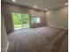 Living room featuring a sliding glass door to the outside, a window, and neutral carpet at 2297 Bay Minette Sta # 536, Apex, NC 27502