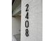 Modern black address numbers displayed vertically on the painted brick facade of the new home at 2408 Eagle Shot Ct # 4, Fuquay Varina, NC 27526