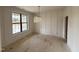 Bright dining room features paneled walls, modern light fixture, and large window overlooking the front yard at 2408 Eagle Shot Ct # 4, Fuquay Varina, NC 27526