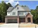 Charming two-story home with a brick-accented facade and attached two-car garage, surrounded by lush greenery at 2408 Eagle Shot Ct # 4, Fuquay Varina, NC 27526