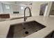 Close up of the kitchen sink and countertops with view into spacious living and kitchen area at 2408 Eagle Shot Ct # 4, Fuquay Varina, NC 27526