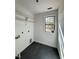 Laundry room with dark tile flooring, shelves, and a bright window at 2408 Eagle Shot Ct # 4, Fuquay Varina, NC 27526