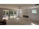 Bright living room boasts a ceiling fan, fireplace, and sliding glass doors to the outdoor deck at 2408 Eagle Shot Ct # 4, Fuquay Varina, NC 27526